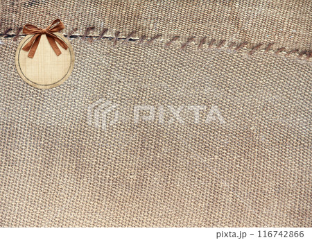 Two pieces of old burlap sewn together with thread. Horizontal background with rustic bag texture Two pieces of old burlap sewn together with thread. Horizontal background with rustic bag texture 116742866