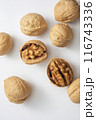 top view photo of walnuts in their shells on a white background 116743336