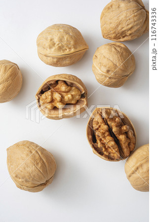 top view photo of walnuts in their shells on a white background top view photo of walnuts in their shells on a white background 116743336