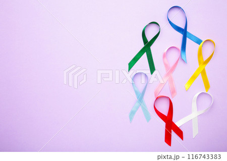 Collection of awareness ribbons on purple with copy space. World cancer day 116743383