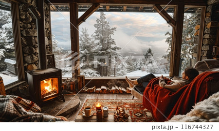 Cozy winter cabin retreat, a crackling fireplace, surrounded by snow-covered pine trees outside, warm blankets, and mugs of hot cocoa Cozy winter cabin retreat, a crackling fireplace, surrounded by snow-covered pine trees outside, warm blankets, and mugs of hot cocoa 116744327