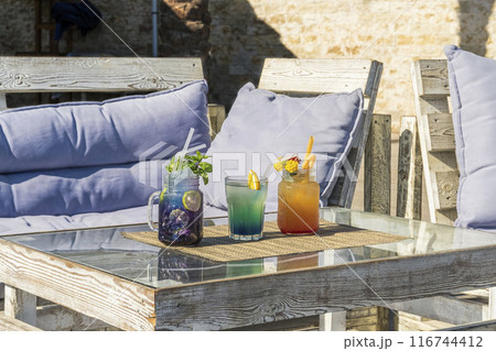 Vibrant Summer Cocktails on Rustic Patio 116744412