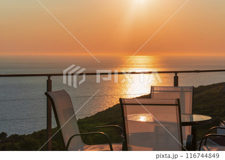 Serene Sunset Dinner with Ocean View from a Balcony 116744849