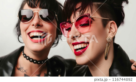 Two Women Wearing Sunglasses and Smiling Two Women Wearing Sunglasses and Smiling 116744892