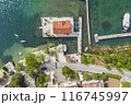 Aerial View of Coastal Town with Waterfront Villa and Clear Blue Waters 116745997