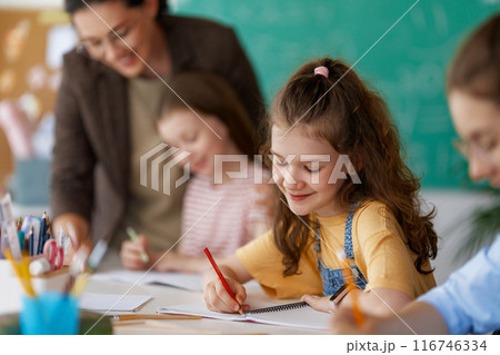 Happy kids and teacher at school 116746334