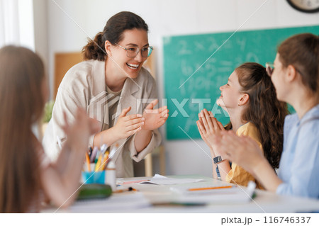 Happy kids and teacher at school 116746337