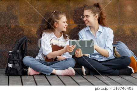 Girls with backpacks outdoors 116746403