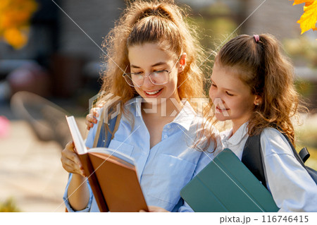 Girls with backpacks outdoors 116746415