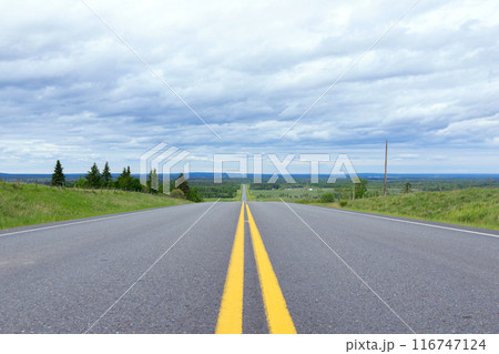 Scenic view from the highway with yellow solid lines in plains. Scenic view from the highway with yellow solid lines in plains. 116747124