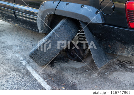 Broken Car Wheel on a Parked Vehicle close-up 116747965