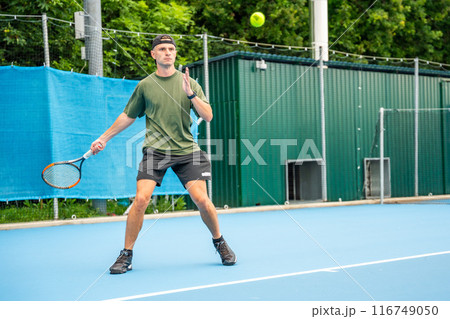 Professional male tennis player playing the tennis on outside court 116749050