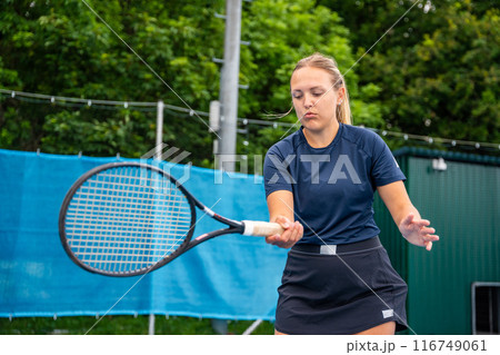 Professional female tennis player playing in tennis with racket and ball on outside court 116749061