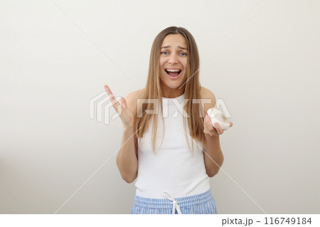 Hair loss problem. Screaming young woman holds hair brush with bunch of fallen hair after combing. Postpartum period, alopecia, symptoms of endocrine disorder, hormonal imbalance, stress concept Hair loss problem. Screaming young woman holds hair brush with bunch of fallen hair after combing. Postpartum period, alopecia, symptoms of endocrine disorder, hormonal imbalance, stress concept 116749184