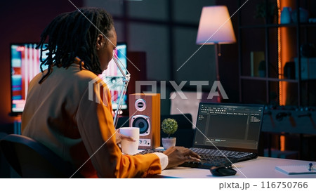 African american IT student practicing coding or programming exercises, learning hardware language and system debugging. Young woman studying database script on html window. Camera A. African american IT student practicing coding or programming exercises, learning hardware language and system debugging. Young woman studying database script on html window. Camera A. 116750766
