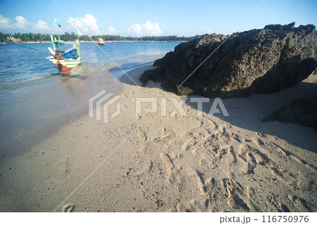 Ngapali rocks and beach There are boats carrying tourists like locals waiting.This beach is Myanmar's most famous beach ,beautiful Consisting of clean white sand beaches, blue sea water. Myanmar. 116750976