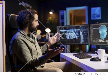 Programmer having shocked expression on face after being asked existential questions by awaken AI on PC. Confused IT specialist bewildered by artificial intelligence able to speak on its own Programmer having shocked expression on face after being asked existential questions by awaken AI on PC. Confused IT specialist bewildered by artificial intelligence able to speak on its own 116751195