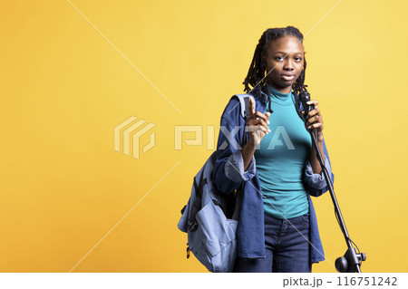 Portrait of african american motivational speaker talking in microphone, addressing audience, isolated over studio background. Expressive BIPOC lecturer using mic, inspiring motivation 116751242