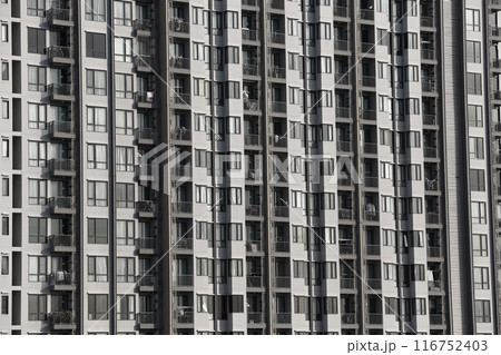 Close up of tall building with a skyscraper background. Close up of tall building with a skyscraper background. 116752403