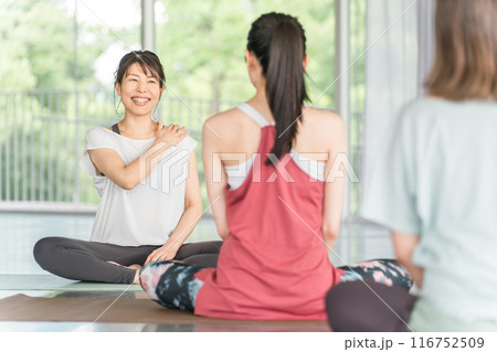 ヨガ教室・ピラティスでヨガ・ネックケア・肩こり対策を指導するヨガ講師・インストラクターの女性 ヨガ教室・ピラティスでヨガ・ネックケア・肩こり対策を指導するヨガ講師・インストラクターの女性 116752509