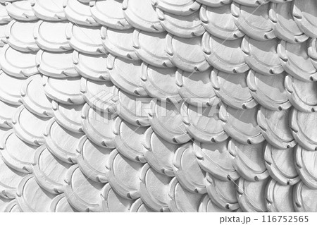 White patterns of stucco shaped like fish scales. White patterns of stucco shaped like fish scales. 116752565