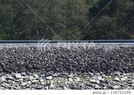 Waterproof rock formation or dam with a road. Waterproof rock formation or dam with a road. 116752599