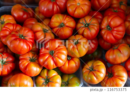 Harvest of ripe tomatoes, displayed for sale in the store 116753375