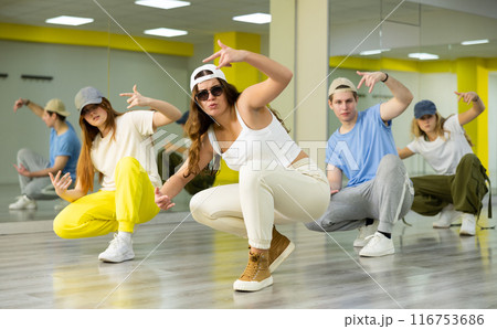Joyous boy and girls dancing hip hop at lesson in class Joyous boy and girls dancing hip hop at lesson in class 116753686