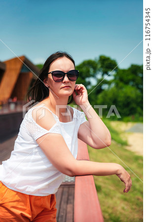 portrait of 36 years old russian woman in sunglasses on the summer day 116754345