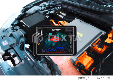 Car technician is checking SOH state of health of battery with a wireless scanner tools 116755086