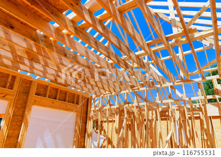 New home that is under construction with timber truss frame has roof joints New home that is under construction with timber truss frame has roof joints 116755531