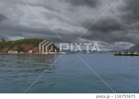 Koh Kham in the rain clouds are coming, The satellite islands of Koh Sichang. Koh Kham in the rain clouds are coming, The satellite islands of Koh Sichang. 116755675
