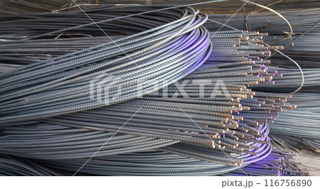 Steel rods or bars used to reinforce concrete, stocked in warehouse. 116756890