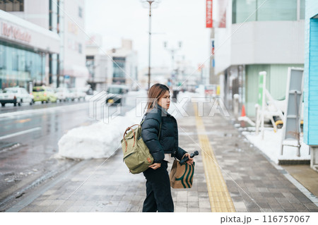 Woman tourist sightseeing Hirosaki city in winter season. Traveler travel Hirosaki Castle in Hirosaki city, Aomori Prefecture, Tohoku, Japan. Landmark for tourist attraction, travel and vacation 116757067
