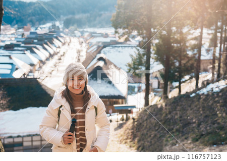 Woman tourist sightseeing Ouchi Juku ancient farmer house village with snow in winter, Traveler travel in Shimogo town, Minamiaizu, Fukushima Prefecture, Tohoku Region, Japan. Landmark and vac Woman tourist sightseeing Ouchi Juku ancient farmer house village with snow in winter, Traveler travel in Shimogo town, Minamiaizu, Fukushima Prefecture, Tohoku Region, Japan. Landmark and vac 116757123