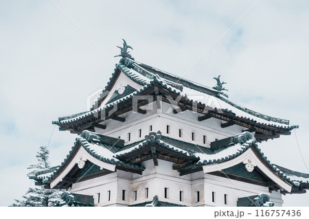 White Hirosaki Castle or Takaoka Castle with snow in winter, hirayama style Japanese castle located in Hirosaki city, Aomori Prefecture, Tohoku, Japan. Landmark for tourist attraction. Japan travel 116757436