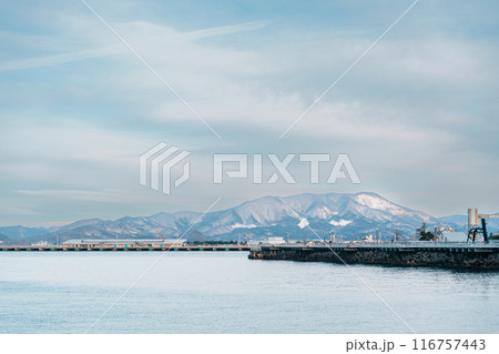 view of ocean and mountains with snow in winter at Aomori Bay Bridge Locate in the city of Aomori in Aomori Prefecture, Japan view of ocean and mountains with snow in winter at Aomori Bay Bridge Locate in the city of Aomori in Aomori Prefecture, Japan 116757443
