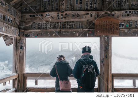 tourist sightseeing view of village with snow in winter from mountain viewpoint of Yamadera temple or Risshakuji temple located in Yamagata City, in Yamagata Prefecture, Tohuku, Japan 116757501