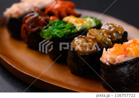 Gunkan maki sushi set on wooden plate, Japanese food Gunkan maki sushi set on wooden plate, Japanese food 116757722