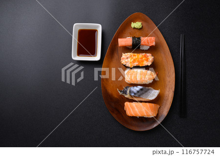 Nigiri sushi set on wooden plate eating with wasabi and sauce, Japanese food, Top view 116757724