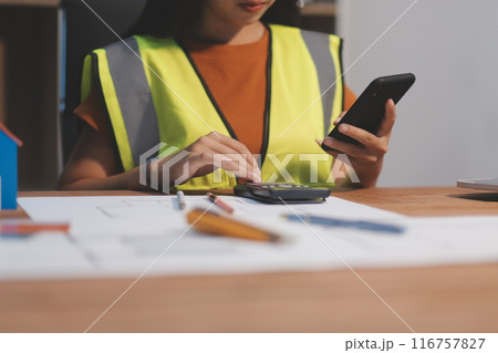 Female architect working at home She looked at the blueprint. 116757827
