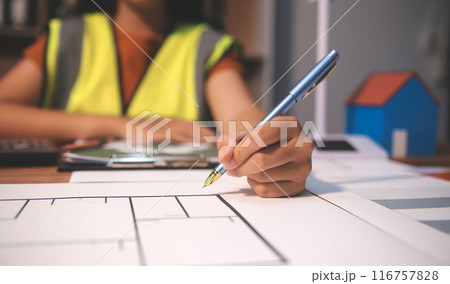 Female architect working at home She looked at the blueprint. 116757828