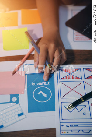The designer team is designing the uxui system to make the uxui system work well on new phones and support system updates. Website development concept UI UX front end designer 116757842