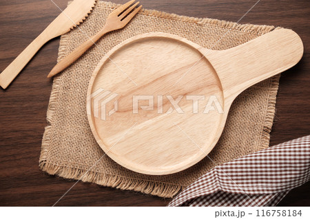 Top Table View Circle wooden plate with handle on wooden background. 116758184