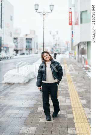 Woman tourist sightseeing Hirosaki city in winter season. Traveler travel Hirosaki Castle in Hirosaki city, Aomori Prefecture, Tohoku, Japan. Landmark for tourist attraction, travel and vacation Woman tourist sightseeing Hirosaki city in winter season. Traveler travel Hirosaki Castle in Hirosaki city, Aomori Prefecture, Tohoku, Japan. Landmark for tourist attraction, travel and vacation 116759944
