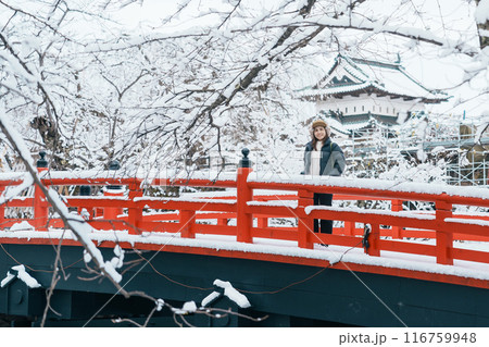 Woman tourist sightseeing Hirosaki Castle in winter, happy traveler travel Hirosaki city, Aomori Prefecture, Tohoku, Japan. Landmark and famous for tourist attraction. Japan travel and vacation Woman tourist sightseeing Hirosaki Castle in winter, happy traveler travel Hirosaki city, Aomori Prefecture, Tohoku, Japan. Landmark and famous for tourist attraction. Japan travel and vacation 116759948