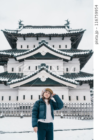 Woman tourist sightseeing Hirosaki Castle in winter, happy traveler travel Hirosaki city, Aomori Prefecture, Tohoku, Japan. Landmark and famous for tourist attraction. Japan travel and vacation 116759954