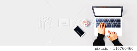 Person using a laptop computer with a small gift box Person using a laptop computer with a small gift box 116760460