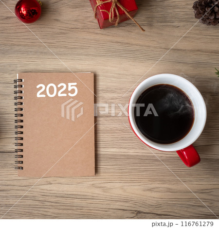 2025 notebook, black coffee cup and Christmas gift on wood table, Top view and copy space. Xmas, Happy New Year, Goals, Resolution, To do list, Strategy and Plan concept 116761279