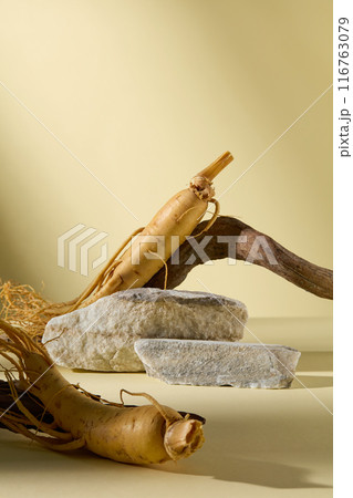 Ginseng extract products advertising photo was shot from frontal over yellow background, in the center having an empty stone podium for product showing. Blank space for adding text Ginseng extract products advertising photo was shot from frontal over yellow background, in the center having an empty stone podium for product showing. Blank space for adding text 116763079